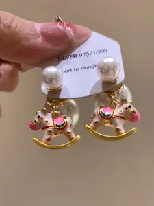 Detailed close-up of cute rocking horse pearl earrings featuring S925 silver needle posts
