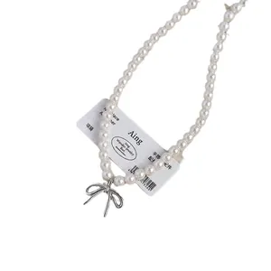 Elegant French style pearl necklace with a silver bow pendant for women's fashion