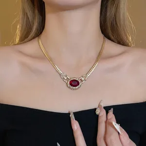 Vintage palace style snake bone necklace with a large red rhinestone pendant for women