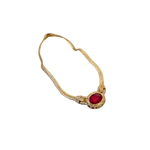 Vintage gold snake bone chain necklace with oval red gemstone and crystal halo