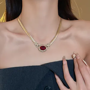 Vintage-style gold snake chain necklace featuring a stunning oval ruby red gemstone detail