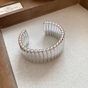 Textured silver-colored geometric open cuff bracelet with minimalist heavy design