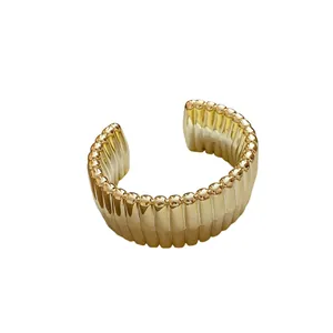Golden textured geometric open cuff bracelet with a stylish ribbed design for women