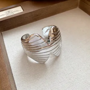 Detailed macro view of the silver ribbed texture on the geometric open cuff bracelet.