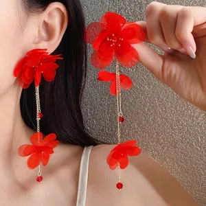 Elegant red chiffon flower long tassel earrings with glass beads worn by an Asian model
