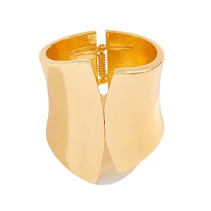Wide asymmetric gold metal cuff bracelet with elegant high-polish finish for women