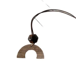 Retro wooden semi-circle pendant necklace with dark bead on a minimalist brown cord.