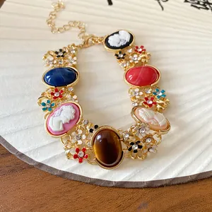 Close-up of vintage French style bracelet with colorful resin cameos and flowers.