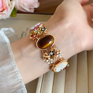 Close-up view of a vintage French style bracelet featuring floral resin cameos and rhinestones