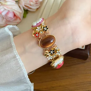 Elegant French vintage gold bracelet with colorful resin flowers and cameo charms