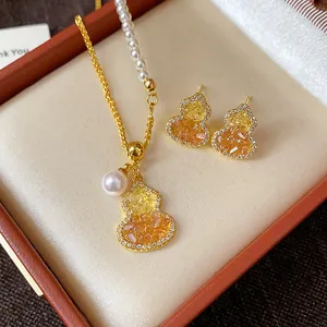 Detail view of gold-plated gourd jewelry set with zircons and pearls