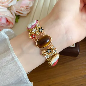 Close-up of vintage French palace style bracelet with resin cameos and floral details