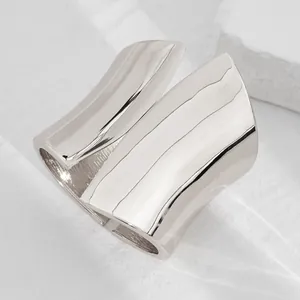 Professional macro detail showing the high-shine finish of asymmetrical silver metal cuff bracelet