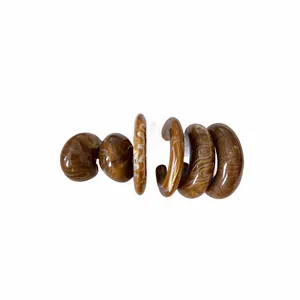 Stylish acrylic C-shaped hoop earrings with brown marbled swirl texture on white background