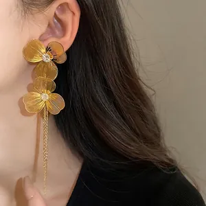 Luxury gold-plated oversized flower tassel earrings for women, model wearing shot