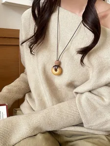 Minimalist retro round pendant necklace with amber-tone resin and a slim cord