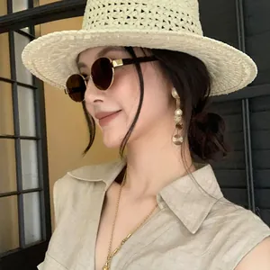 Elegant gold textured round disk tassel earrings worn by stylish Asian model for summer