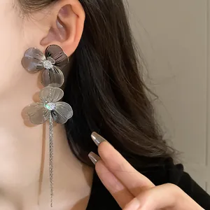 Elegant silver-tone flower earrings featuring long delicate chain tassels and crystals