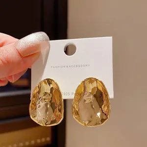 Fashionable irregular textured gold metal stud earrings with S925 silver needle.