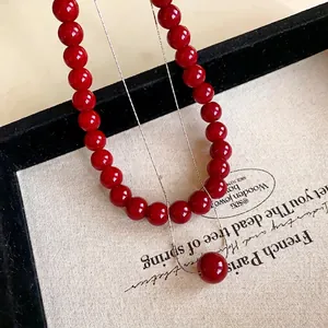 Elegant red bead necklace set with minimalist silver chain and round pendant charm