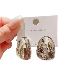 Modern irregular hammered metallic silver stud earrings featuring S925 silver needle