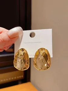 Macro view of hammered gold irregular stud earrings with S925 silver posts
