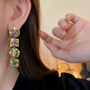 Elegant vintage style gold drop earrings with multi-colored crystals and hammered metal texture