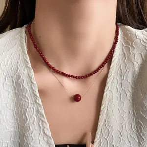 Close-up of elegant double-layered Ankora red pearl necklace on model's neck