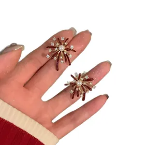 Elegant firework-shaped pearl stud earrings with red glaze and sparkling zircons