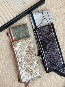 Close-up of paisley pattern silk scarves in various colors and styles.