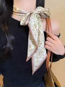 Detail view of a chic paisley print neck scarf necklace tied into a stylish bow knot.