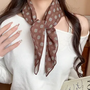 Elegant vintage brown fabric scarf with white daisy floral print worn as a stylish neckerchief
