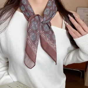Detailed close-up of a vintage brown printed floral bandana worn as a stylish neck scarf