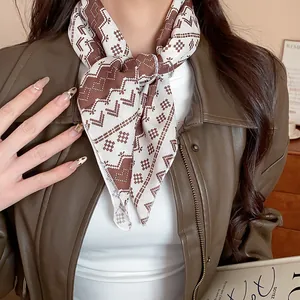 Close-up detail of a vintage geometric pattern scarf worn as a stylish brown neckerchief