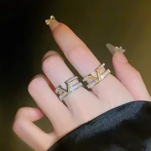 Close-up detail of a double-layer V-shaped open ring with sparkling cubic zirconia