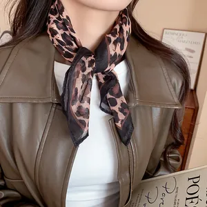 Detailed view of a vintage leopard print fabric square scarf elegantly tied around the neck.