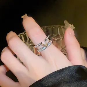 Close-up detail of an elegant double-layered zircon ring featuring a golden V-shape.