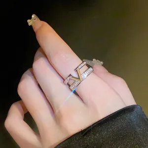 Close-up view of a double-layered gold plated ring with zircon stones and V-shape motif