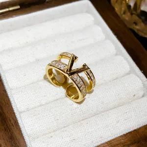 Detailed view of a gold-plated double-layer V-shaped ring with zircons in a jewelry box