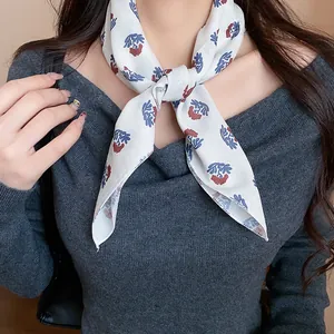 Close-up of retro floral fabric scarf tied around neck for a stylish look