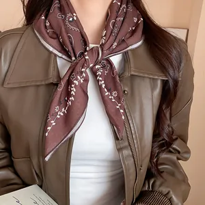Close-up of vintage brown paisley floral print bandana tied as a stylish neck scarf
