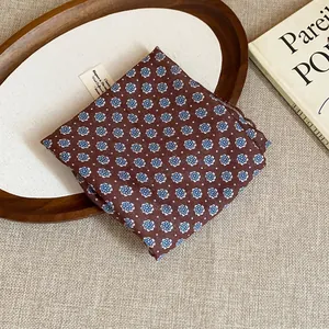 Detail of vintage floral print cotton headscarf with blue daisy pattern on brown fabric