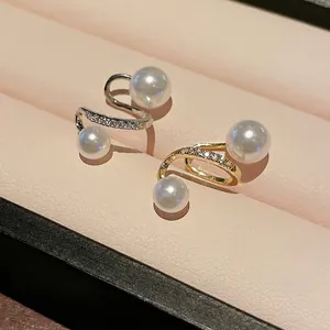 Elegant gold plated S-shaped ear clips with white pearls and sparkling zircon accents