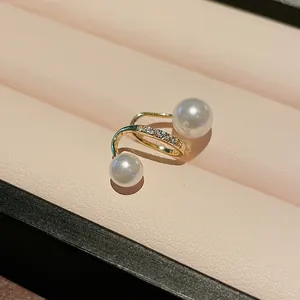 Close-up of elegant gold plated ear cuff featuring white pearls and paved zircons