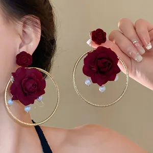 Detail view of French vintage rose hoop earrings with pearls and silver needle