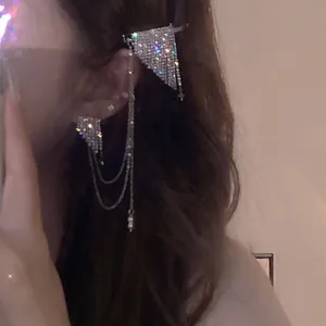 Detailed view of sparkling rhinestone fringe earrings with elegant chain hair clips