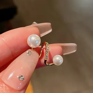 Close-up of gold-plated ear cuff with pearls and zircons for non-pierced ears.