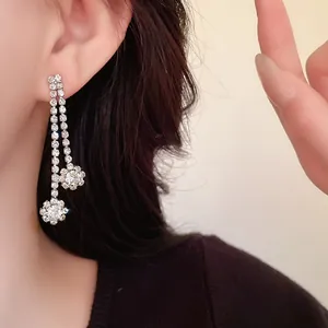 Close-up of elegant silver rhinestone long tassel earrings for wedding dress accessories.
