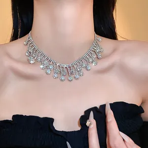Elegant silver-toned tassel fringe necklace with sparkling rhinestones on model