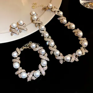 Detail showing the rhinestone-paved X-links and pearls of the vintage jewelry set.